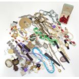 A quantity of assorted costume jewellery to include beads, brooches, earrings, etc. with some silver