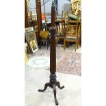 A mid 20thC turned and carved mahogany standard lamp on tripod base. Approx. 60" high Please