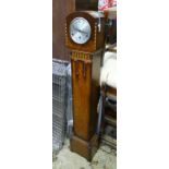 An Art Deco style longcase clock. Approx. 54 1/2" high Please Note - we do not make reference to the