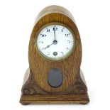 An oak mantle clock. Approx. 9" high Please Note - we do not make reference to the condition of lots