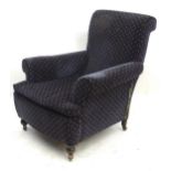 A 20thC upholstered armchair. Approx. 36" high overall Please Note - we do not make reference to the