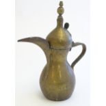 A Middle Eastern / Turkish brass Dallah coffee pot with banded detail to lid. Approx. 13 3/4" high