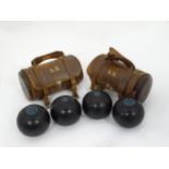 Four lawn boules balls / bowling balls manufactured by W. D. Hensell & Son within two leather
