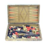 Toy: A folding backgammon board / games box formed as a book, containing assorted chess pieces,