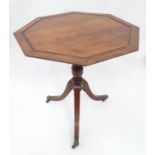 An octagonal tilt top occasional table. Approx. 25" high x 24" wide Please Note - we do not make
