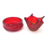 Two items of mid 20thC red studio glass, comprising a vase stamped with flower motif under, and a