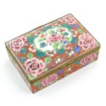 An Oriental box with a hinged lid decorated with peony flowers and foliage, with floral motifs