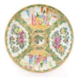 A Chinese / Cantonese famille rose charger with panelled decoration depicting figures on a