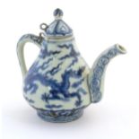 A Chinese blue and white teapot decorated with dragons amongst stylised scrolling clouds. Approx. 6"