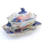A Chinese export famille rose lidded tureen and stand decorated in the tobacco leaf pattern with