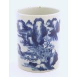 A Chinese blue and white brush pot of cylindrical form decorated with a stylised landscape with
