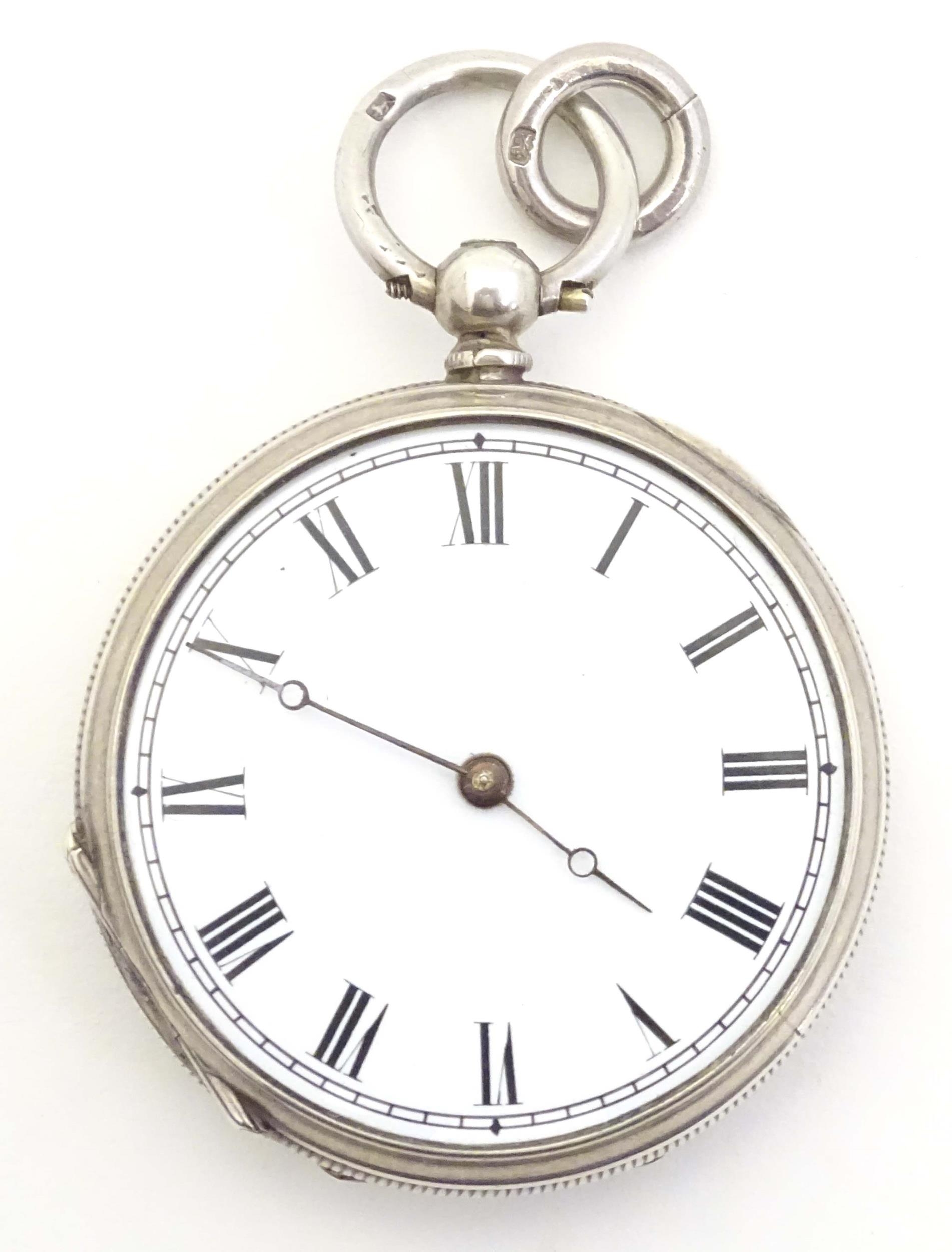 A white metal pocket watch. Approx. 1 1/2" diameter Please Note - we do not make reference to the