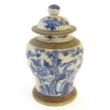 A Chinese blue and white ginger jar with a crackle glaze, the body decorated with a bird in a