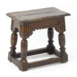 A 17thC and later oak joint stool with a moulded top above a base of peg jointed construction,