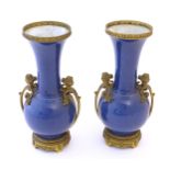 A pair of Oriental bottle vases with flared rims and applied gilt metal mounts with Classical