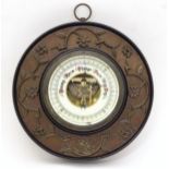 An Aneroid barometer by Lufft mounted within an ebonised surround. 9" diameter Please Note - we do