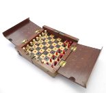 Toys: A late 19th / early 20thC Whittington style travelling chess board with a quantity of turned