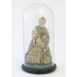 A 20thC bisque doll with a plated dress and bead necklace, within a glass dome. Dome approx. 10"