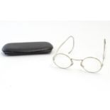 A pair of 20thC / WWII respirator glasses / spectacles with instructions on how to wear when using a