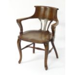 A mid / late 19thC mahogany clerks chair with a pierced fan back splat flanked by swept arms and