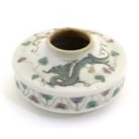 A Chinese brush wash of circular form decorated with dragons amongst stylised clouds. Character