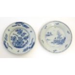 A Chinese blue and white plate decorated with stylised flowers and foliage. Together with another