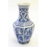 A Chinese blue and white vase of octagonal form with panelled decoration depicting various