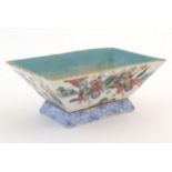 A Chinese footed dish of rectangular form decorated with imperial style figures and attendants on