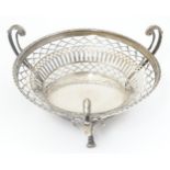 A silver three footed basket with pierced decoration, hallmarked Birmingham 1911. Approx. 6 3/4"