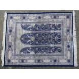 Carpet / rug: A blue ground rug with column and arch with floral and scroll detail. Approx. 66 1/