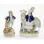 Two Victorian Staffordshire pottery figures depicting a girl with a large sheep, and young