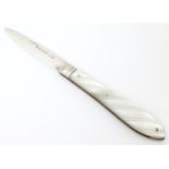 A Victorian silver folding fruit knife with mother of pearl handle. Hallmarked London 1874 maker