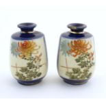 A pair of small Japanese vases decorated with chrysanthemum flowers and foliate detail with gilt