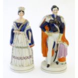 Two Victorian Staffordshire pottery figures depicting Queen Victoria, and Prince Albert. Largest