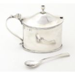 A Victorian silver mustard pot with a blue glass liner, hallmarked London 1894. Together with an