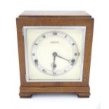 An Elliot of London Art Deco mantel clock, the dial with retailers details for Wm Burford & Son