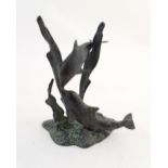 A 20thC cast bronze sculpture modelled as two dolphins swimming. Approx. 7 1/2" high Please Note -