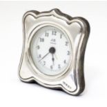 A late 20thC alarm clock with silver surround hallmarked Birmingham 1993 maker John Bull Ltd.
