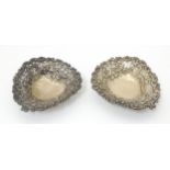 Two Victorian silver bon bon dishes of heart shape with embossed and pierced decoration,