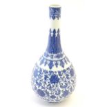 A Chinese blue and white bottle vase decorated with scrolling flowers and foliage, the neck with