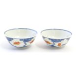 A pair of Chinese bowls decorated with stylised bats amongst clouds. Character marks under.