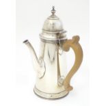 A George V silver chocolate pot with wooden side handle and hinged domed lid, hallmarked London