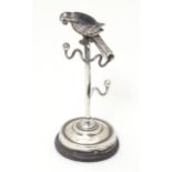 A silver ring stand / tree surmounted by a parrot. Hallmarked Birmingham 1908 maker Adie & Lovekin