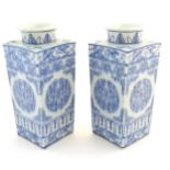 A matched pair of Chinese blue and white Cong shaped vases, with a tall square tapering body with