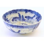 A large Chinese blue and white bowl with a scalloped edge, the body decorated with koi carp fish