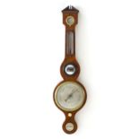 A 19thC walnut cased wheel barometer the dial signed J Caracia East Grinstead. 39" long Please