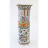 A Chinese / Cantonese vase of cylindrical form with a flared rim decorated with figures, birds,