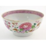 A Chinese bowl decorated with flowers and foliage, with floral motif to centre of interior and