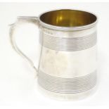 A George III silver mug of tankard form with banded decoration, hallmarked London 1819, maker