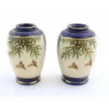 A pair of small Japanese vases decorated with birds and foliage with gilt highlights. Character